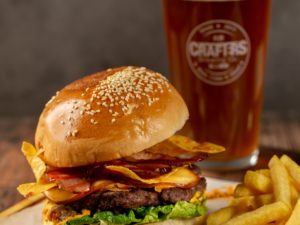 Burger dinner with a striptease show at a sports bar for your bachelor party in Budapest.